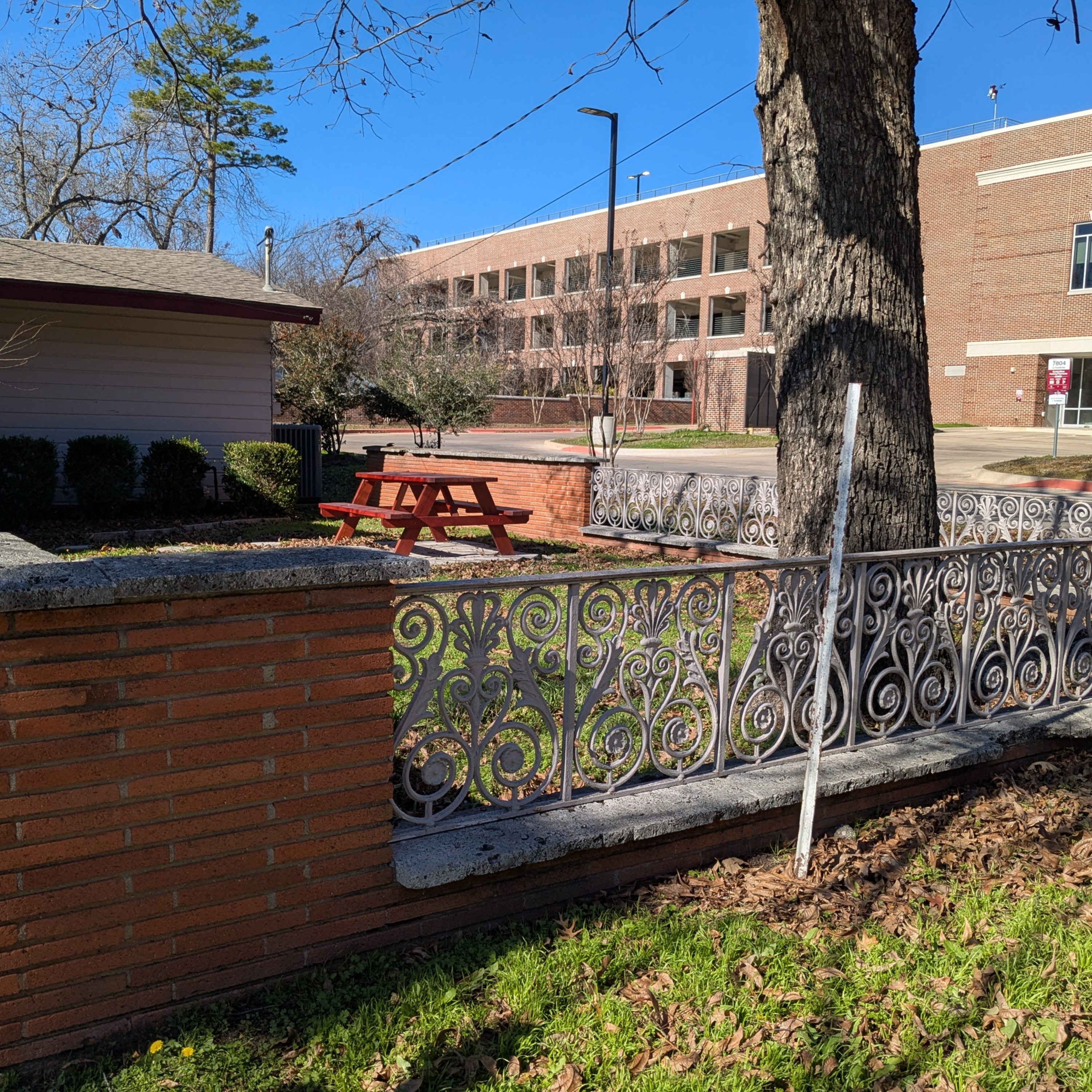 Fenced area in front of the TWU Baptist Student Union building.