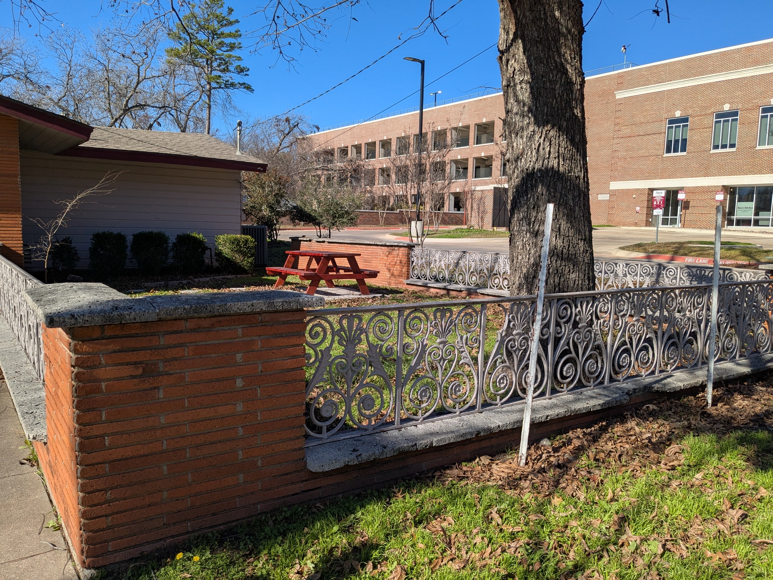 Fenced area in front of the TWU Baptist Student Union building.